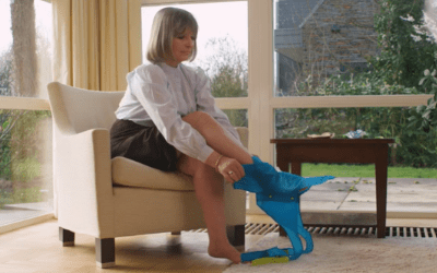Woman puts foot in the steve glide clipper stockingaid for compression socks
