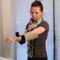 woman puts on her arm sleeve with donning device Steve EasyON